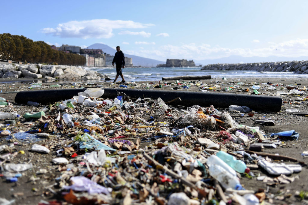 A beach in Naples covered with plastic waste and debris